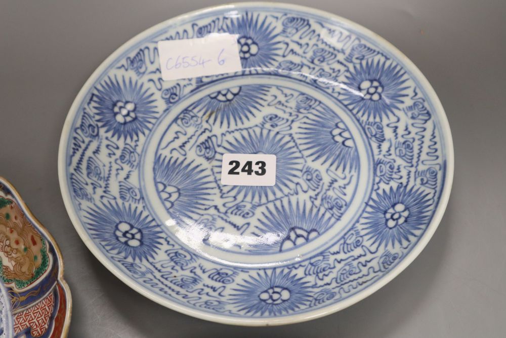 Two Japanese Arita dishes and a Chinese blue and white dish, largest diameter 24cm